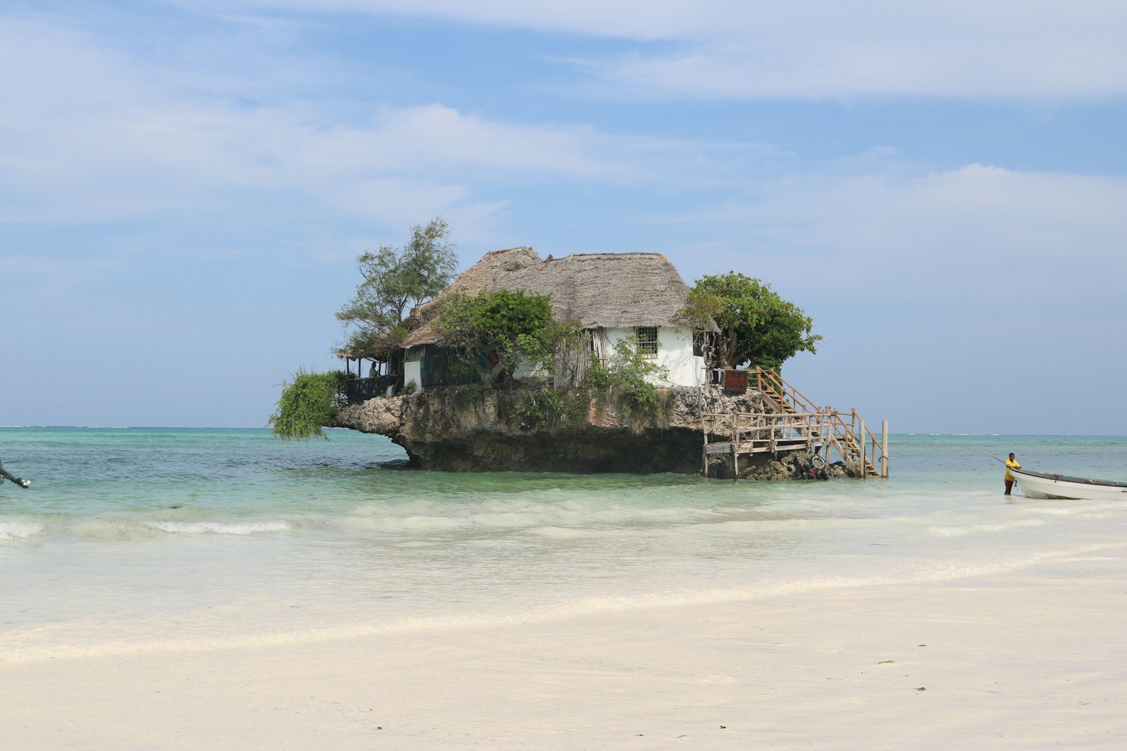 a house on an island in the middle of the ocean